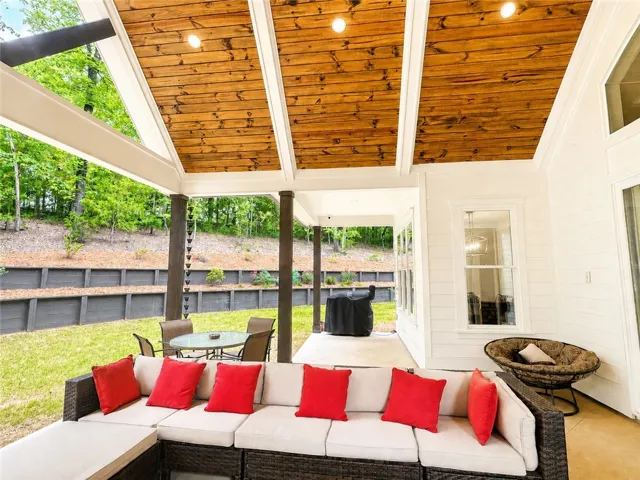 Covered patio offers an inviting outdoor living space with grilling area