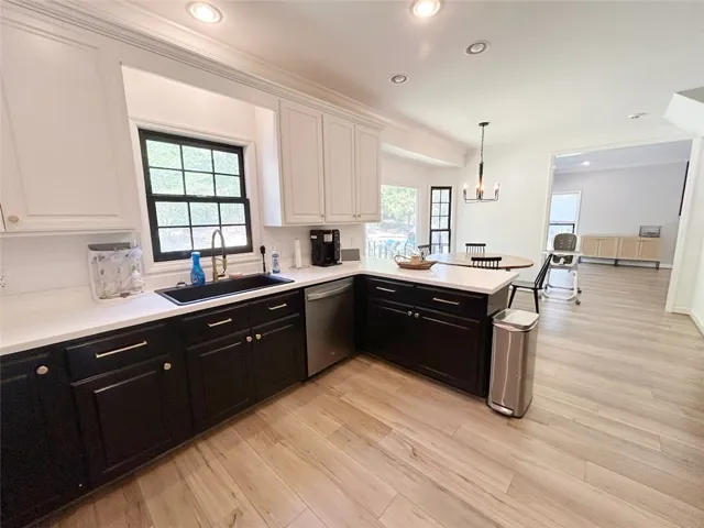 This modern kitchen features a spacious island and bright ambiance, perfect for culinary endeavors.