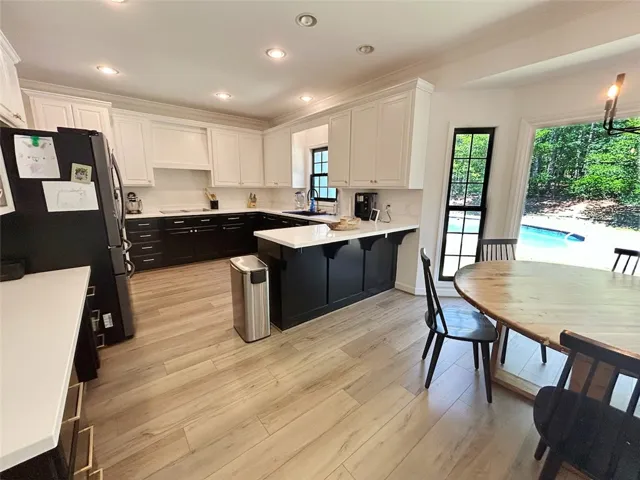 This kitchen offers modern design with ample counter space and scenic views of the pool.