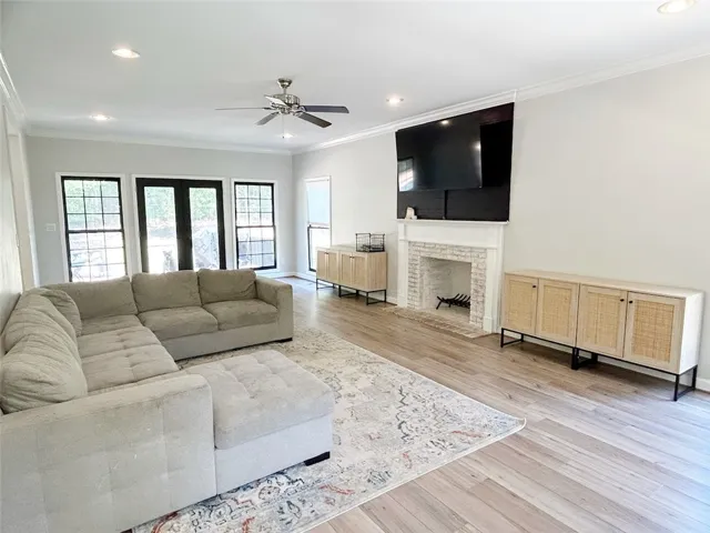 This bright living area features a fireplace and wood floors, perfect for daily living and entertaining.
