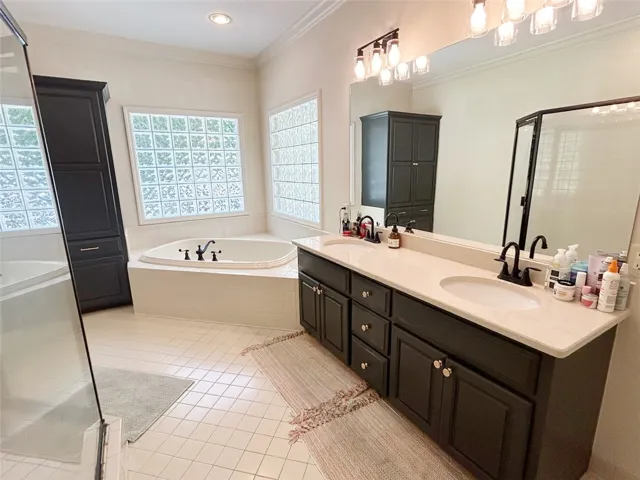 This spacious bathroom offers a relaxing soaking tub and dual vanity.