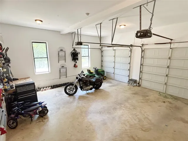 This spacious garage offers ample storage and features convenient overhead doors.