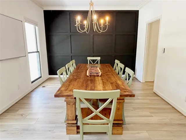 This bright dining area features a unique accent wall and ample natural light.
