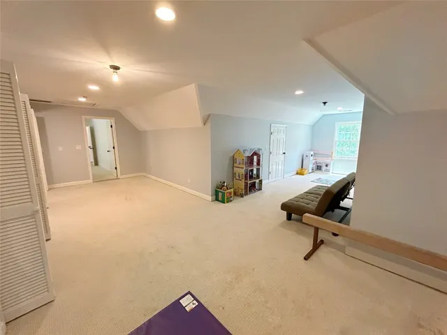 Bright and spacious room with vaulted ceilings and ample natural light offers versatile living.
