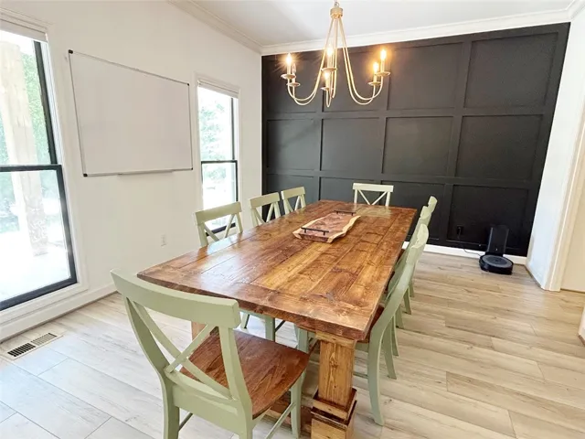 This bright dining area features ample natural light and elegant wall detailing.
