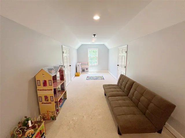 This spacious bonus room features soft carpet and ample natural light, perfect for versatile use.