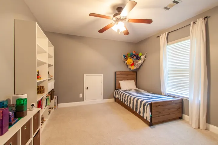 This cozy bedroom offers a comfortable retreat with ample natural light.
