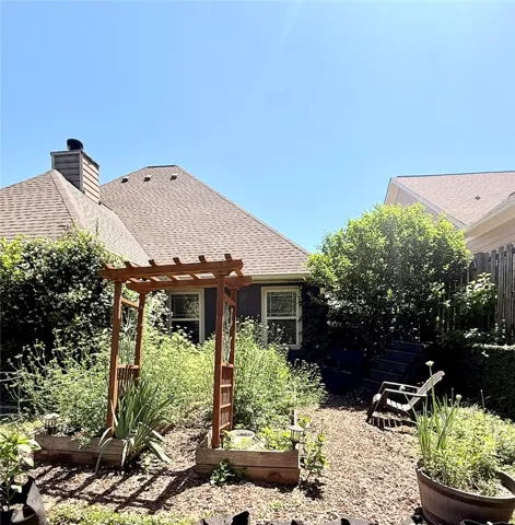 This tranquil backyard sanctuary offers a charming garden and a peaceful outdoor escape.