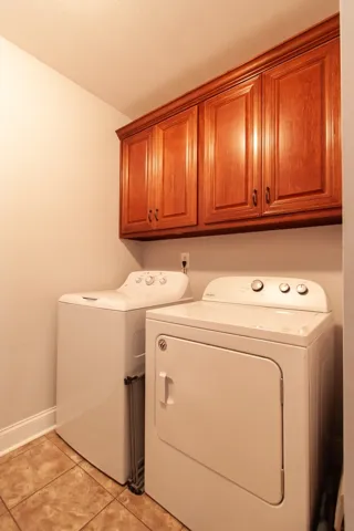 This dedicated laundry space combines functionality with storage for ultimate convenience.