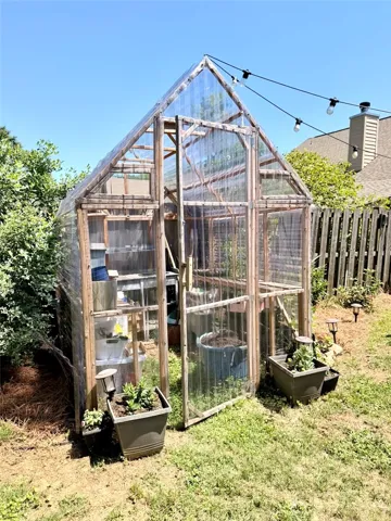 Cultivate your green thumb in this charming backyard greenhouse.