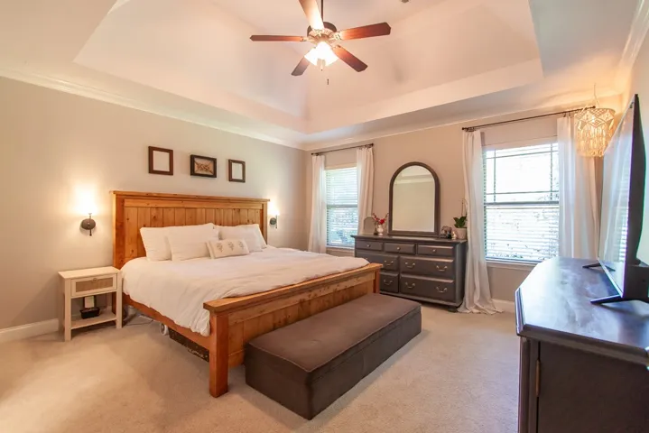 This peaceful bedroom provides a comfortable retreat with ample natural light.