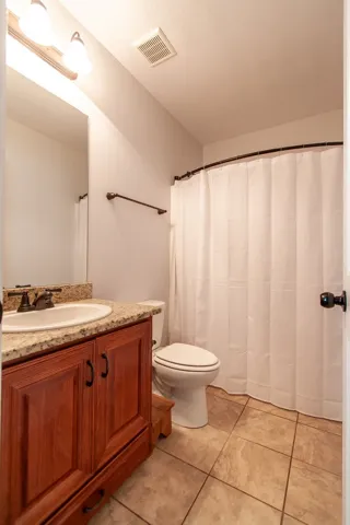 This bathroom features a functional layout with classic finishes and a tiled floor.