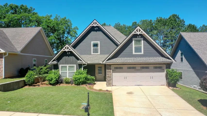 This charming home offers curb appeal with mature landscaping and a welcoming entrance.