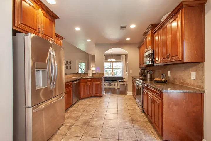 This spacious kitchen offers ample cabinetry and an inviting atmosphere.