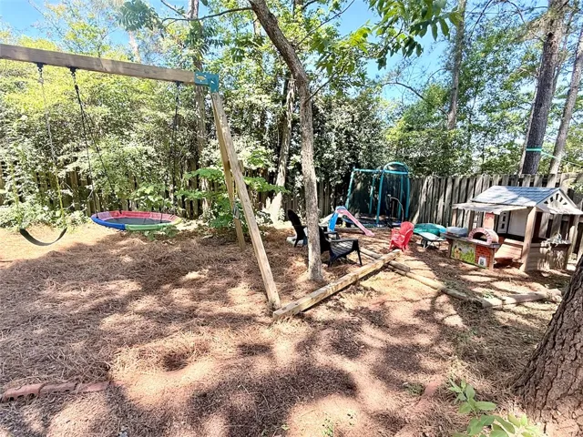 This spacious yard offers ample room for play and relaxation amidst lush greenery.