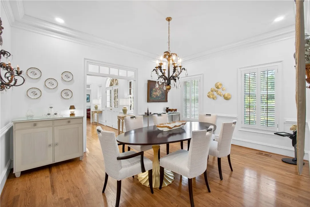 This dining room offers hardwood flooring, crown molding, and bright windows, perfect for entertaining.