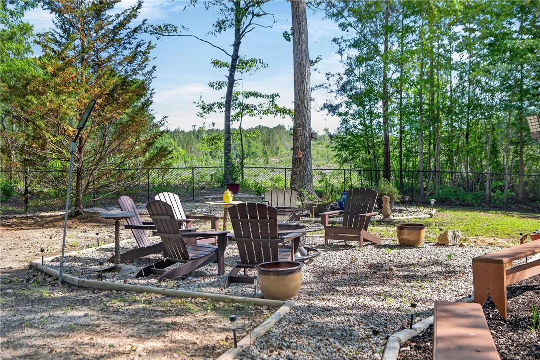 This private outdoor space features a gravel patio, perfect for gathering around a fire pit.