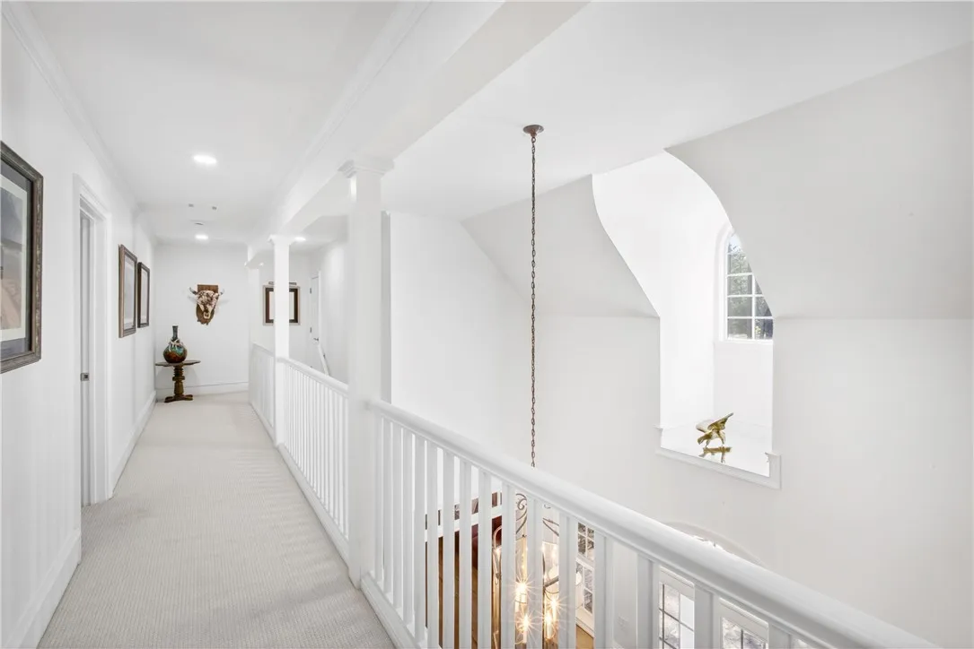 This bright hallway connects elegant spaces, offering a sophisticated transition between rooms.