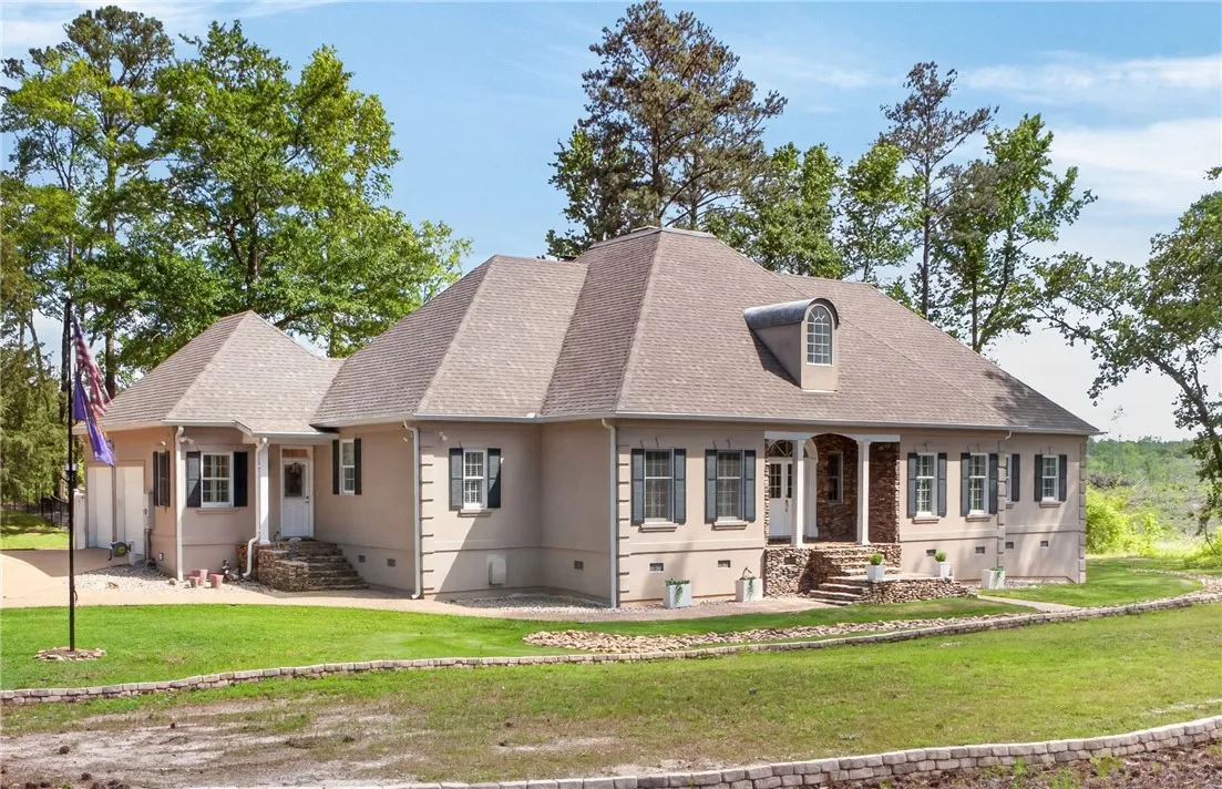 Elegant entrance with a grand portico and stacked stone accents welcomes you to this expansive home.
