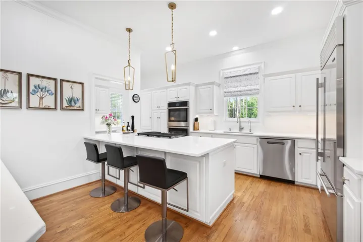 This spacious kitchen offers a central island, modern appliances, and ample cabinetry for culinary pursuits.