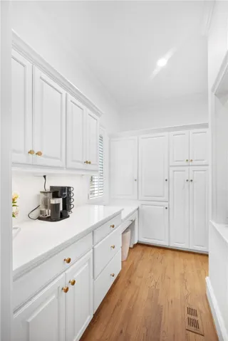 This bright and functional space features ample storage and hardwood flooring.