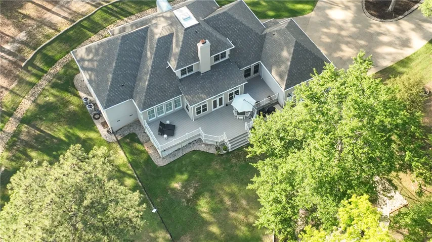 This aerial view showcases a spacious residence with an expansive outdoor deck.