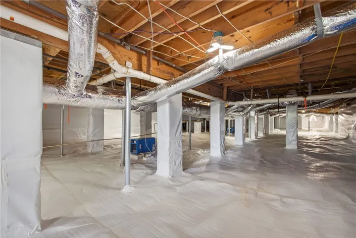 This meticulously encapsulated crawl space offers a clean and protected foundation for optimal home health.