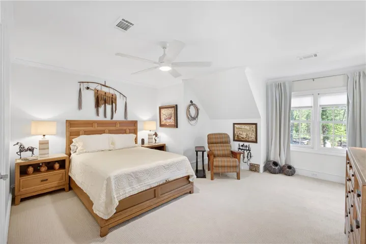 This spacious bedroom offers comfortable living with ample natural light.