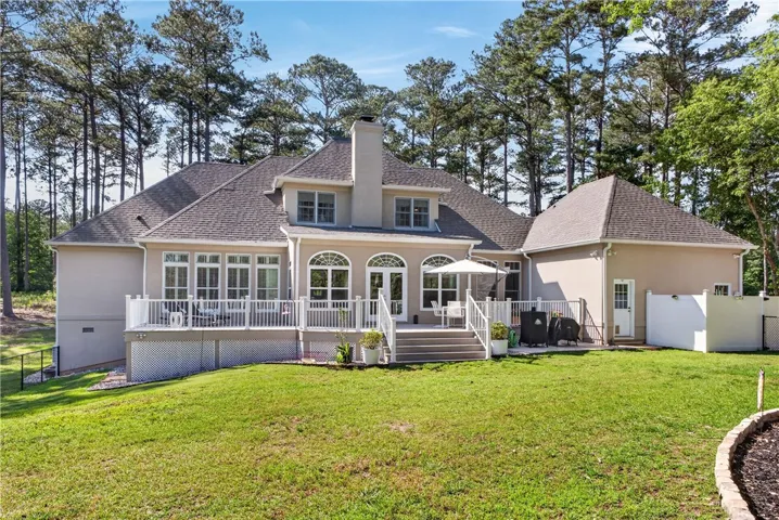 This residence features an expansive deck with multiple access points, perfect for outdoor enjoyment.