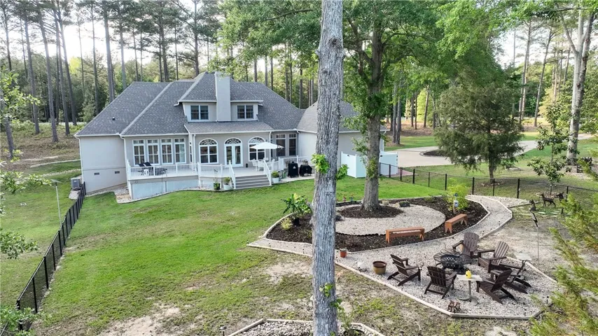This spacious home boasts a serene backyard with a large deck, perfect for outdoor enjoyment.