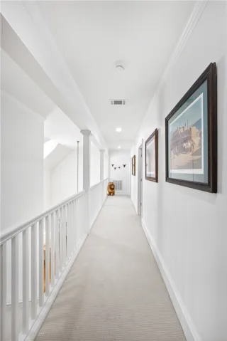 This bright hallway connects spaces with clean lines and soft underfoot comfort.