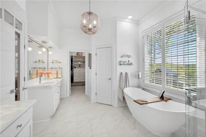 This spacious bathroom offers a relaxing retreat with ample natural light.
