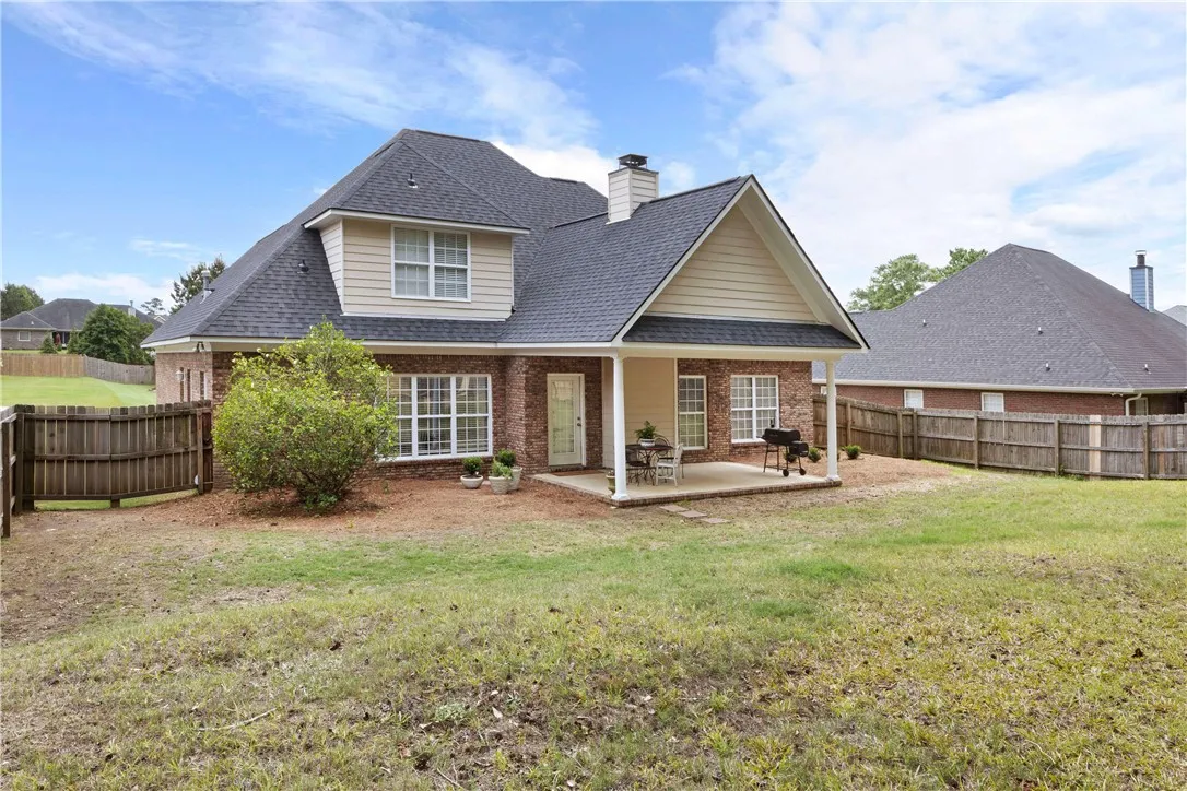 This charming home offers a spacious private yard and a covered patio for outdoor enjoyment.