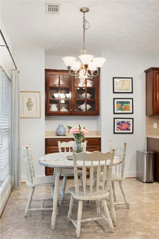 This cozy breakfast area features warm cabinetry and elegant flooring, perfect for morning gatherings.