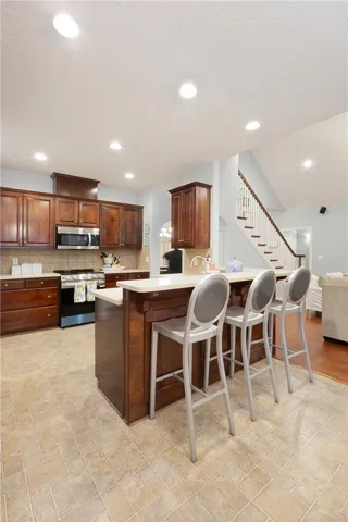 This spacious kitchen offers a functional layout with direct access to an elegant staircase.