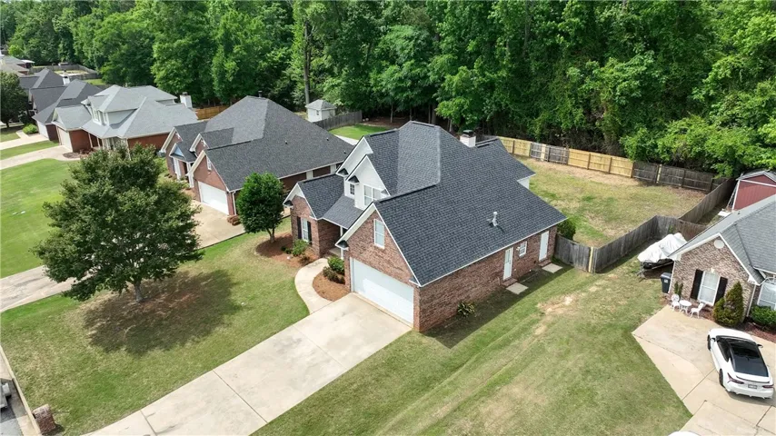 An aerial view showcases a residential neighborhood with well-maintained homes and lush greenery.