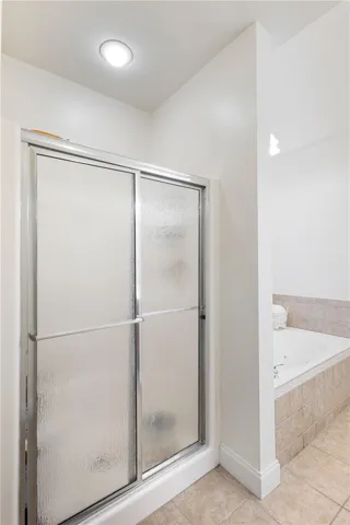 This private bath features a shower and a soaking tub.