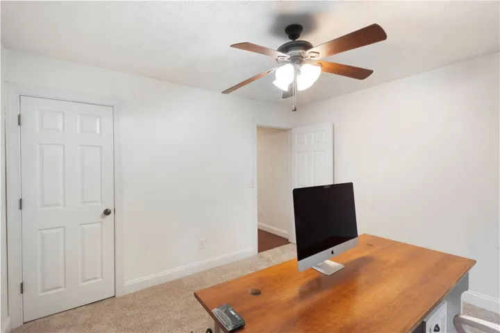 This versatile room offers carpeted comfort and bright potential for various uses.