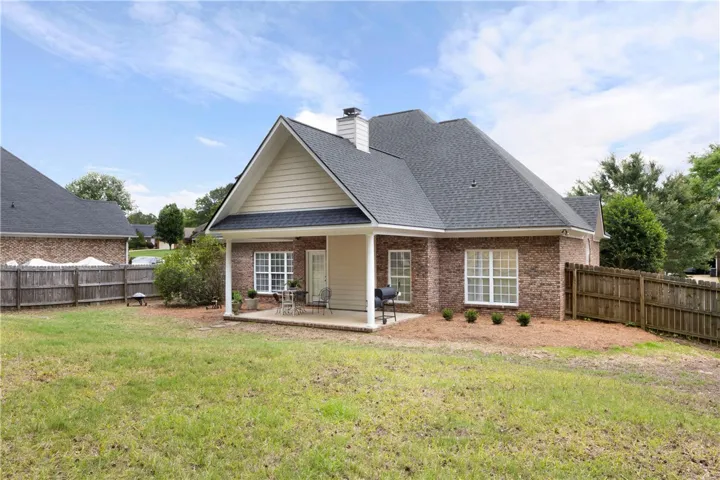 This charming home offers a private yard and a covered patio perfect for outdoor enjoyment.