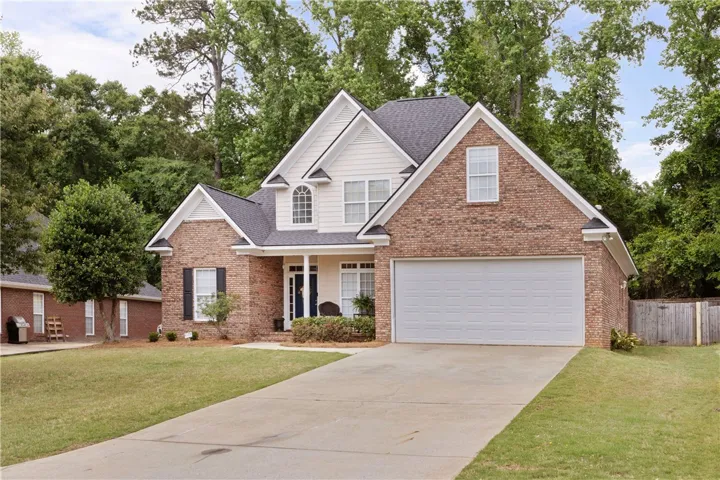This charming residence features a classic brick exterior and a welcoming front entrance.