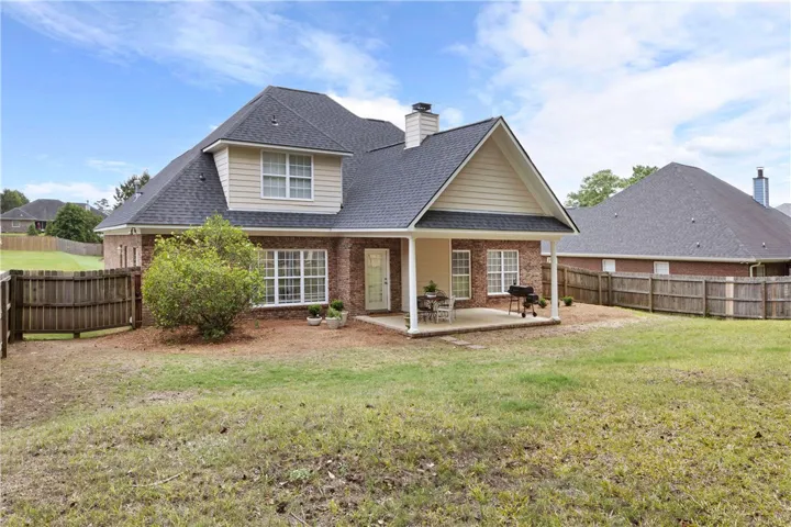 This charming home offers a spacious private yard and a covered patio for outdoor enjoyment.