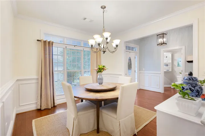 This elegant dining space features rich hardwood flooring and classic crown molding.