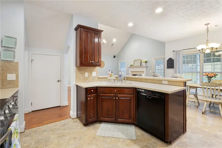 This spacious kitchen offers ample cabinet space and flows into a bright dining area with vaulted ceilings.