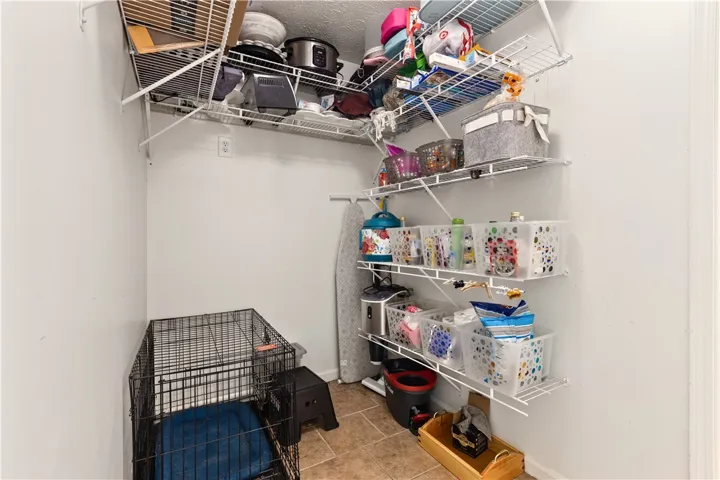 Organized utility space adj kitchen provides efficient storage and functionality for everyday needs.