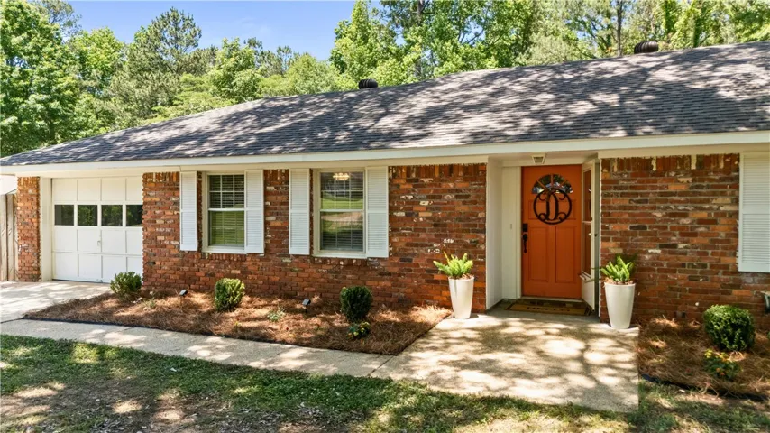 Attractive brick home with young roof & single car garage.
