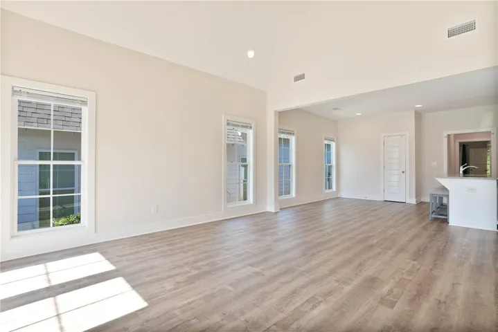This expansive room offers abundant natural light and versatile living space.