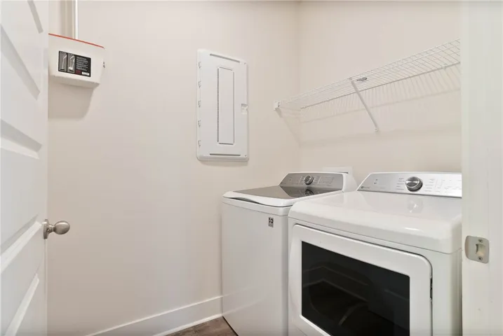 This laundry area features essential appliances and convenient storage solutions.