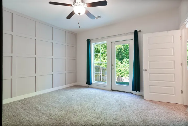 This spacious bedroom offers ample light and a private outdoor connection.