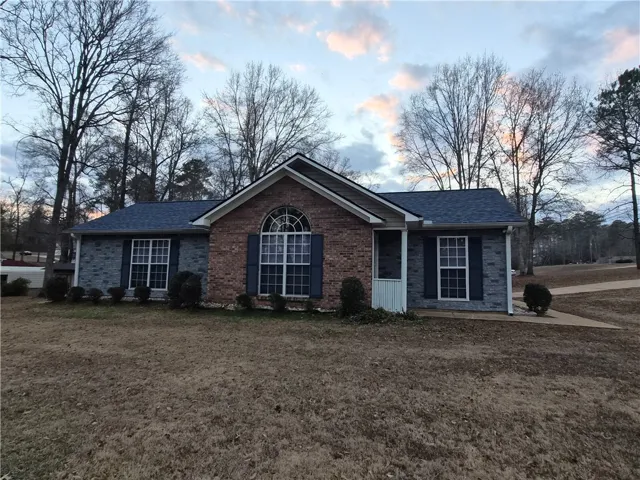 This charming home offers a timeless aesthetic with its durable construction materials and inviting facade.