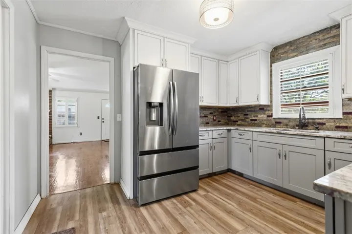This updated kitchen offers ample counter space and a new refrigerator.